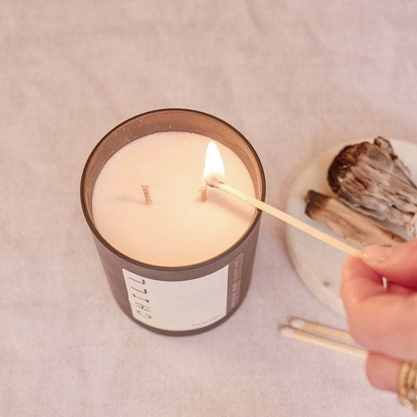 a candle with two wicks and matches