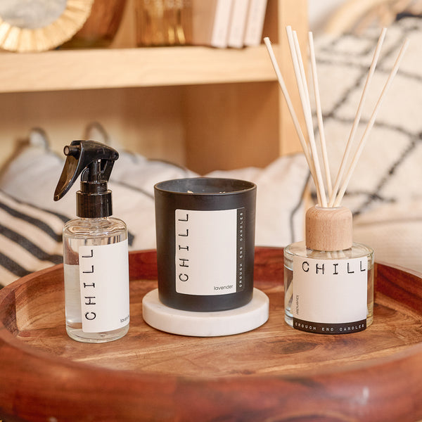 Three 'CHILL' products on a wooden tray with a blurred background