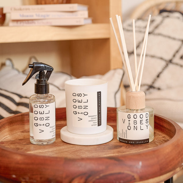 Decorative items with 'Good Vibes Only' text on a wooden tray.