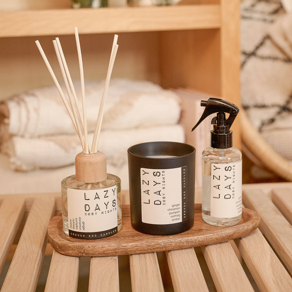 Three 'Lazy Days' products on a wooden tray with a blurred background