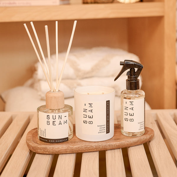 Three 'Sunbeam' products on a wooden tray with a blurred background