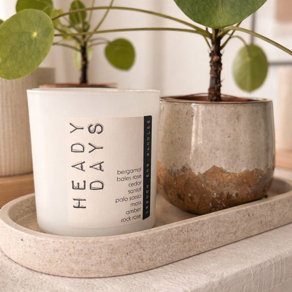 CANDLE on a tray with 'HEADY DAYS' branding on a neutral background
